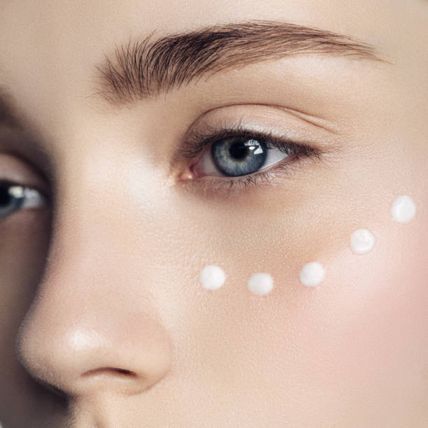 Beautiful woman with cream dots on the face